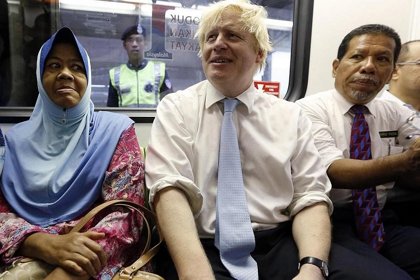 London Mayor Boris Johnson riding the monorail during an official visit to Kuala Lumpur on Dec 1, 2014. On his way home after visiting Malaysia, he was caught up in a mid-air drama when he tried to calm a passenger who became abusive and violent on t