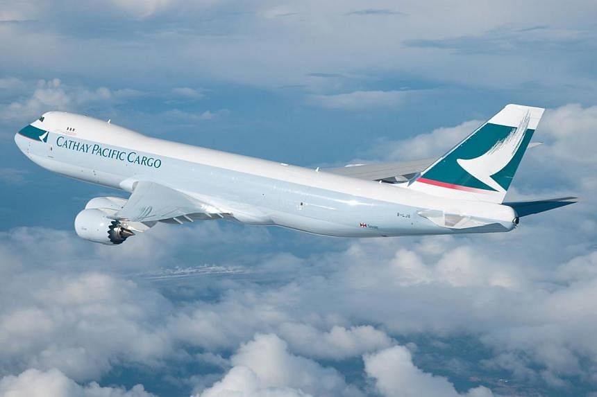 A Cathay Pacific cargo plane. Pilots of the Hong Kong flag carrier were due to start work-to-rule action on Thursday after long-running pay talks broke down, raising the prospect of delays and cancellations in the run-up to Christmas. -- PHOTO: CATHA