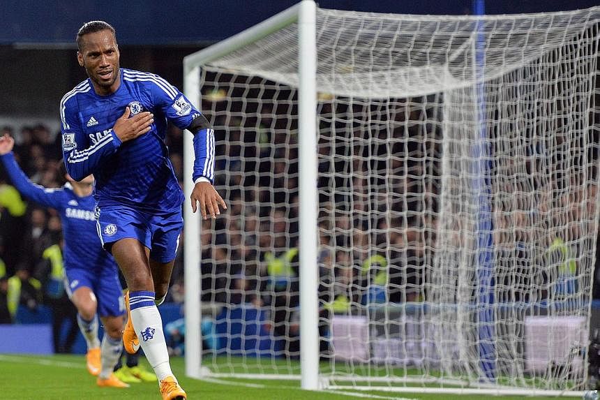 Chelsea's Ivorian striker Didier Drogba celebrates scoring their second goal during the English Premier League football match between Chelsea and Tottenham Hotspur at Stamford Bridge in London on Dec 3, 2014. -- PHOTO: AFP