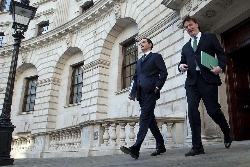 Britain's Chancellor of the Exchequer George Osborne (left) and Chief Secretary to the Treasury Danny Alexander leave the Treasury to present the Autumn Statement to Parliament in London Dec 3, 2014. -- PHOTO: REUTERS