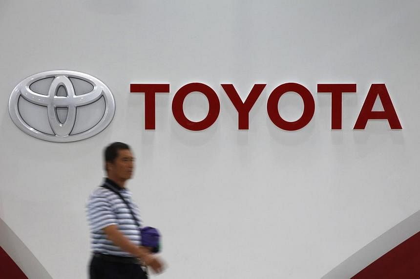 A man walks past Toyota Motor's logo at the company's showroom in Tokyo on Nov 5, 2014.&nbsp;-- PHOTO: REUTERS