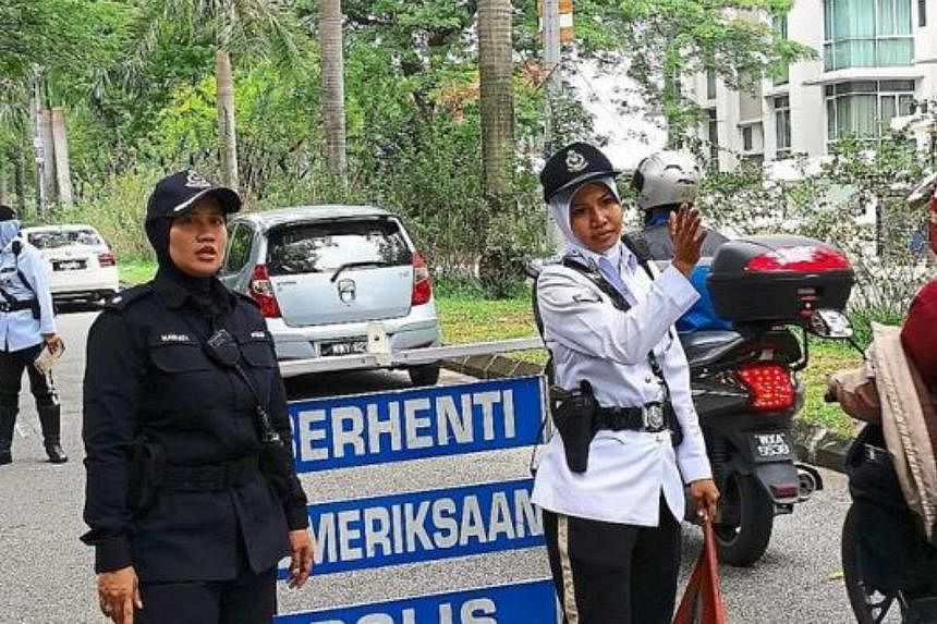 The all-woman police team manning a roadblock in Petaling Jaya. -- PHOTO: THE STAR/ASIA NEWS NETWORK