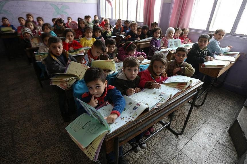 Syrian children at a school in the government-held side of the war-torn northern city of Aleppo on Nov 17, 2014. The Rahmatan Lil Alamin Foundation (RLAF), together with mosques in Singapore, hopes to raise at least $350,000 for a school for children