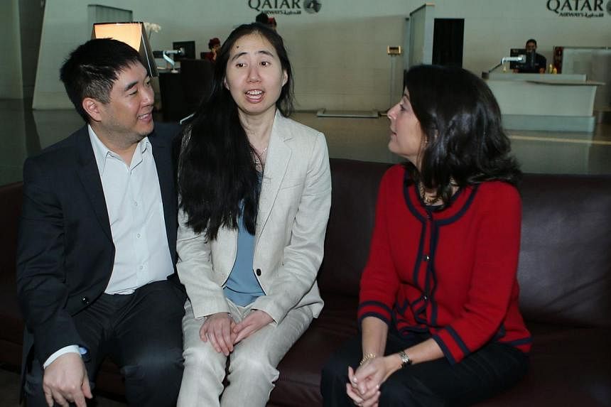 US ambassador to Qatar Dana Shell Smith (right) sits next to freed US couple Grace and Matthew Huang as they wait for their flight at Doha international airport on Dec 3, 2014.-- PHOTO: AFP&nbsp;