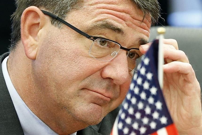 US Deputy Secretary of Defense Ashton Carter adjusts his glasses during his meeting with Japanese Senior Vice Defence Minister Shu Watanabe in Tokyo on July 20, 2012.&nbsp;President Barack Obama on Friday will name former Pentagon deputy chief Ashton