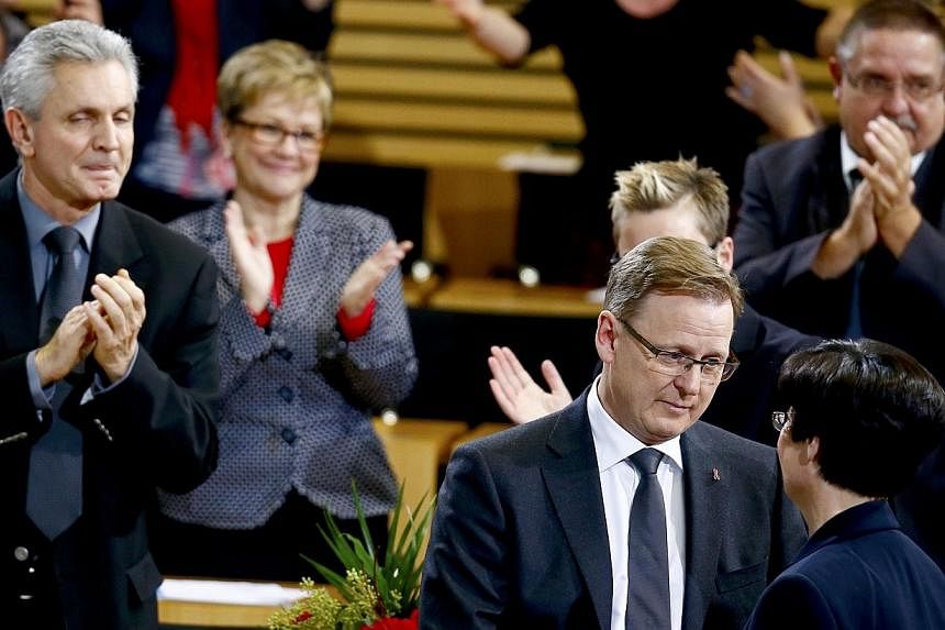 Bodo Ramelow (second right) of the Left party (Die Linke) is congratulated by Christine Lieberknecht, former state premier of Thuringia, after succeeding her, in parliament in Erfurt on Dec 5, 2014.&nbsp;Germany's far-left took the helm of a state as