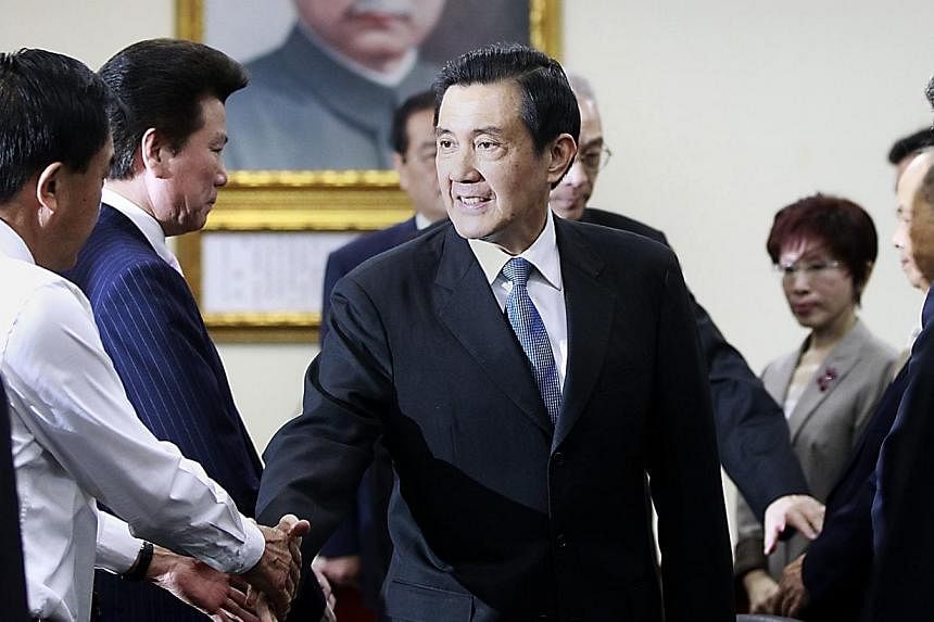 Taiwan President Ma Ying-jeou (centre) shakes hands with Kuomintang (KMT) party officials after announcing his resignation from the party's chairman position during their central standing committee in Taipei on Dec 3, 2014.&nbsp;Taiwan put most of it