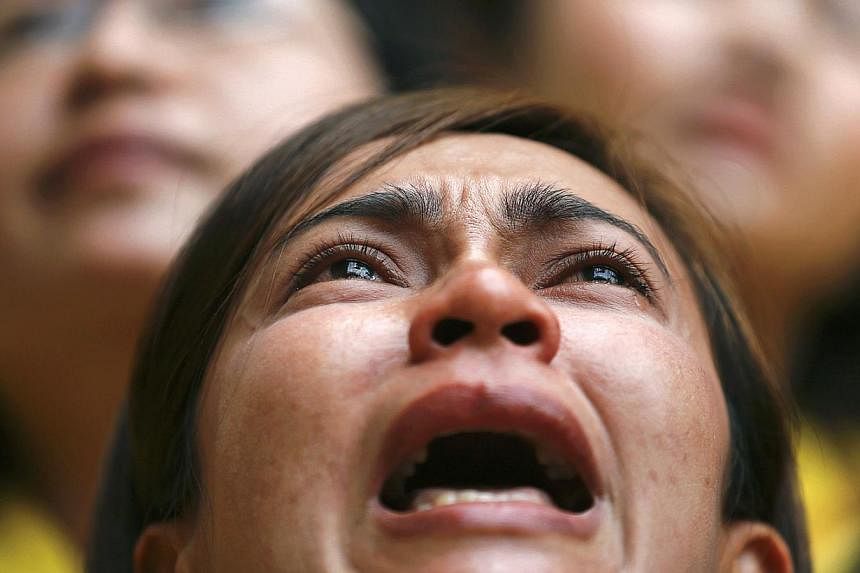 &nbsp;A well-wisher cries under the building where Thailand's King Bhumibol Adulyadej is residing at, in Siriraj hospital,Bangkok. The King cancelled a public appearance on his 87th birthday today on the advice of doctors, disappointing thousands cam