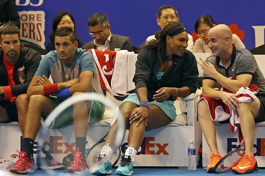 Tennis star Serena Williams and legend Andre Agassi chatting on the sidelines at the opening day of the Singapore leg of the International Premier Tennis League on Dec 2, 2014.&nbsp;Agassi said he was embarrassed at his cameo on Thursday after he was