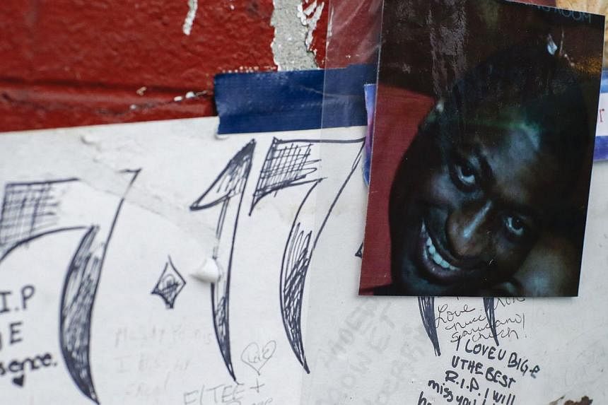 A photo of Eric Garner is displayed at a makeshift memorial, where he died during an arrest in July, at the Staten Island borough of New York, Dec 3, 2014. -- PHOTO: REUTERS&nbsp;