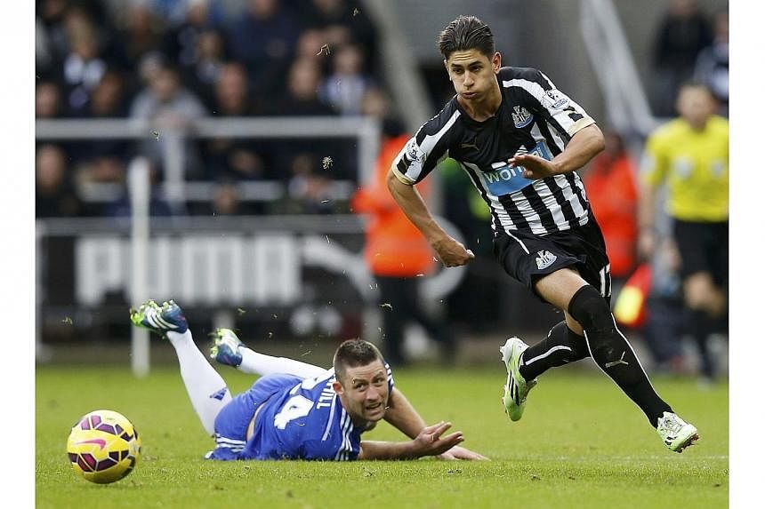 Newcastle's Ayoze Perez runs past Chelsea's Gary Cahill during their English Premier League match at St James' Park on Dec 6, 2014. -- PHOTO: REUTERS&nbsp;