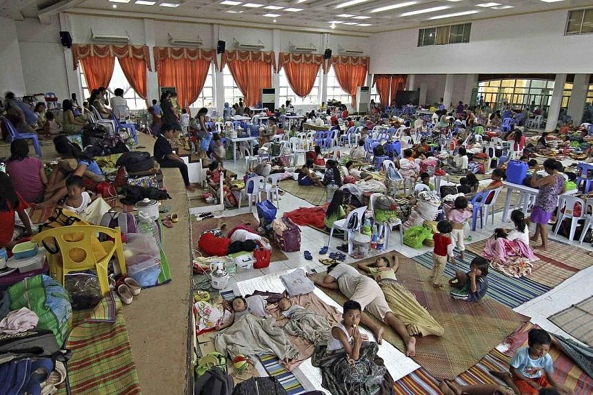 People take shelter in an evacuation centre after leaving their homes in Surigao city in the southern Philippines, where Typhoon Hagupit is expected to make landfall. -- PHOTO: REUTERS