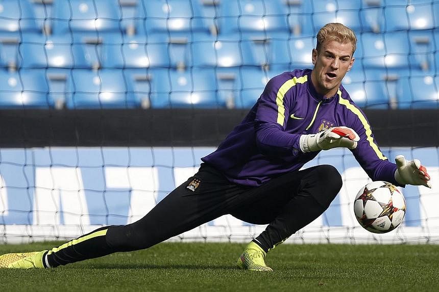 Manchester City's Joe Hart takes part in a training session at Etihad Stadium in Manchester, northern England on Sept 29, 2014. -- PHOTO: REUTERS