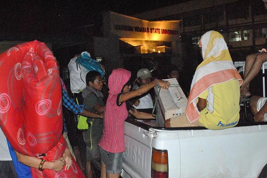 Residents arrive on a vehicle with their beloingings at an evacuation center in Tacloban City, central Philippines, on Dec 5, 2014, ahead of the landfall of Typhoon Hagupit. -- PHOTO: AFP