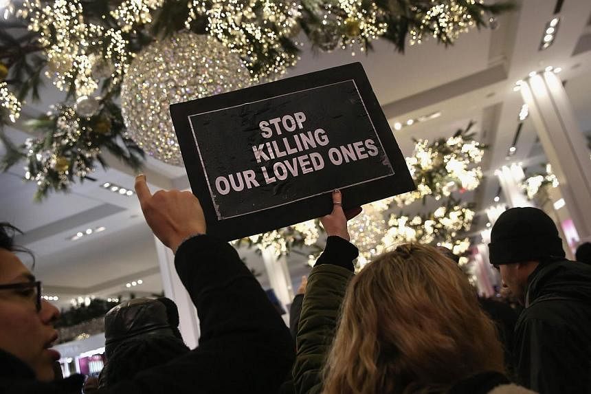 Demonstrators march through Macy's before staging a "die-in" at the iconic department store in Midtown Manhattan on Dec 5, 2014 in New York City. -- PHOTO: AFP