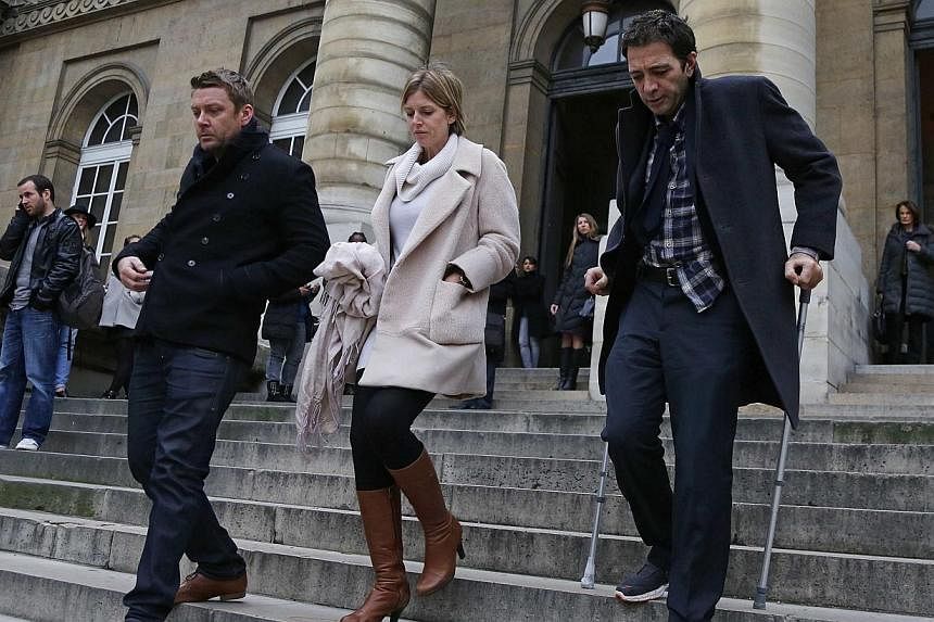 British businessman Ian Griffin (right) and his partner Tracy Baker (centre), descend the steps of the Paris courts Dec 5, 2014 during a break in proceeding in his murder trial. Griffin was jailed for 20 years by a Paris court on Friday for murdering