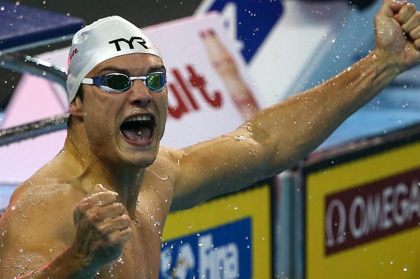Florent Manaudou of France reacts after winning the Men's 50m Freestyle and setting a new world record during the 12th FINA World Swimming Championships (25M) in Doha on Dec 5, 2014. -- PHOTO: AFP