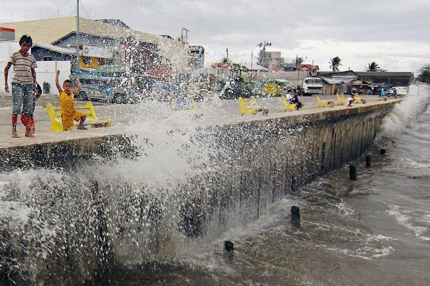 Waves, brought by Typhoon Hagupit, hit the concrete barrier along the Boulevard Seaport in Surigao City in the southern Philippines on Dec 6, 2014. -- PHOTO: REUTERS