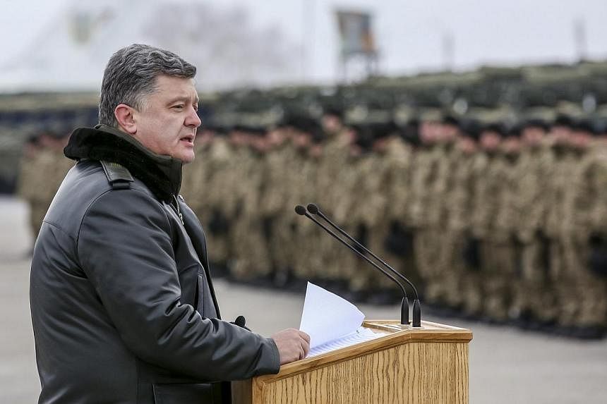 Ukrainian President Petro Poroshenko said Saturday that his envoy would attend a crucial round of peace talks with pro-Russian rebels in the Belarussian capital Minsk next week. -- PHOTO: REUTERS