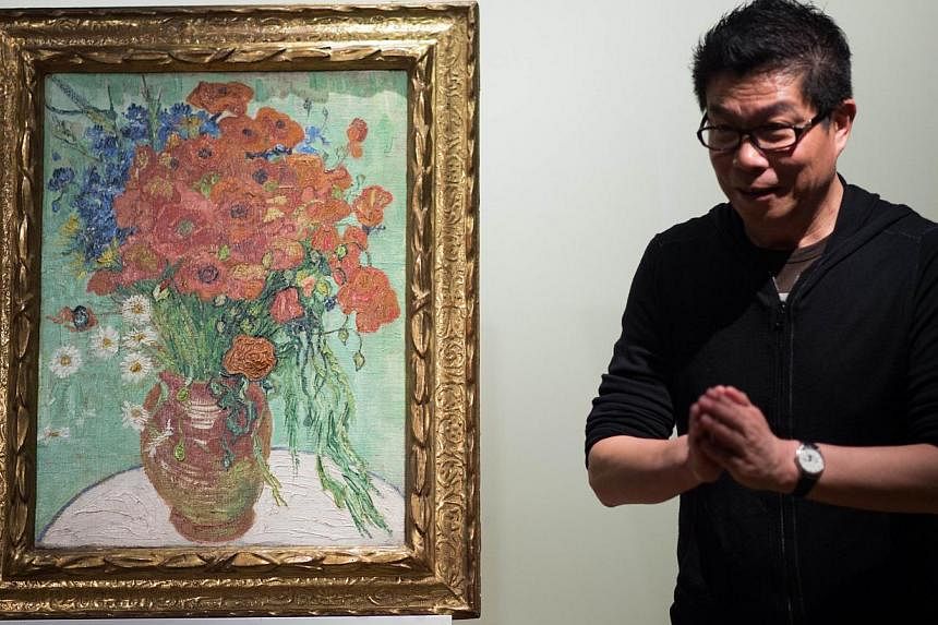 Wang Zhongjun, chairman of the high-powered Huayi Brothers film studio, stands next to his Vincent van Gogh 1890 still life painting Still Life, Vase With Daisies And Poppies, at Sotheby's Hong Kong Gallery in Hong Kong on Dec 6, 2014. -- PHOTO: AFP