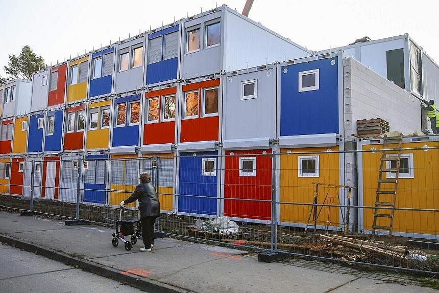 Workers fix containers at a construction site for a refugee centre to house asylum seekers in Berlin on Nov 27, 2014.&nbsp;German businesses would like to see asylum seekers given quicker access to the jobs market, saying they could benefit Europe's 