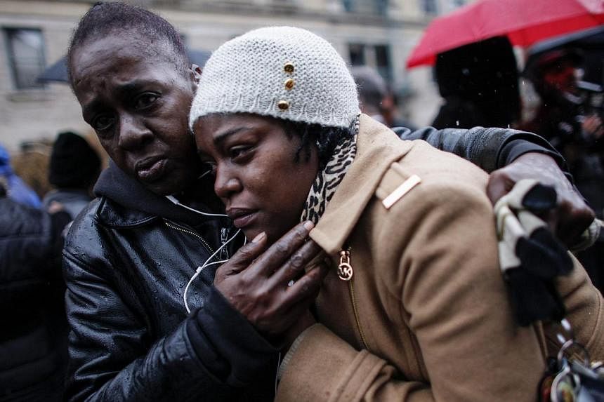 Family members of Akai Gurley attend his funeral service at the Brown Memorial Baptist Church on Dec 6, 2014 in the Brooklyn borough of New York City. Gurley was an unarmed 28-year-old man killed by New York City police officer Peter Liang in a housi
