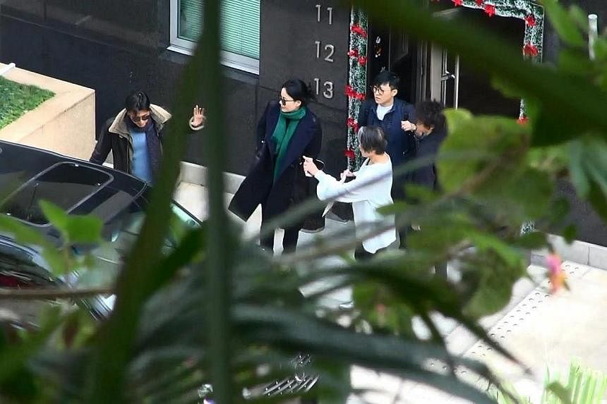 Wong and her daughter emerge from her manager Katie Chan's apartment in Repulse Bay with Nicholas Tse (left).&nbsp;-- PHOTO:&nbsp;APPLE DAILY