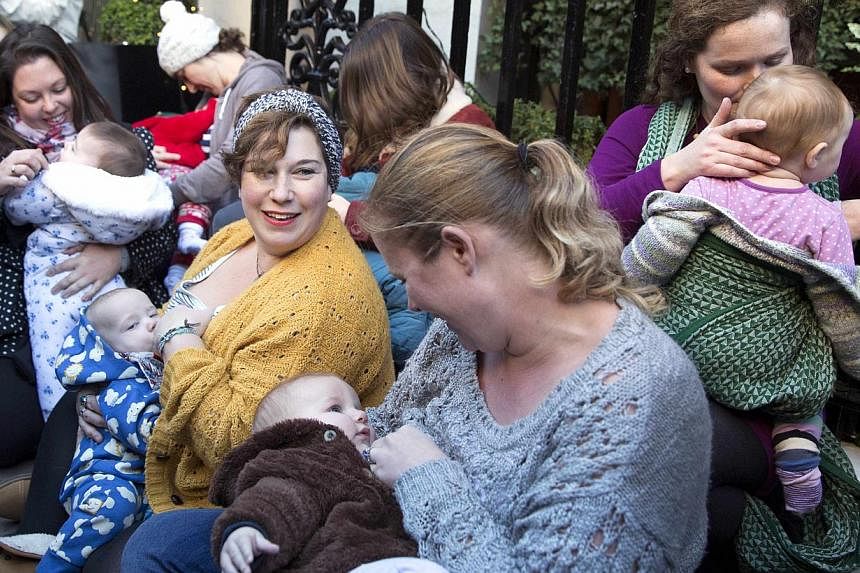 Demonstrators feed their babies during a protest in support of breastfeeding in public, outside Claridge's hotel in London Dec 6, 2014. -- PHOTO: REUTERS