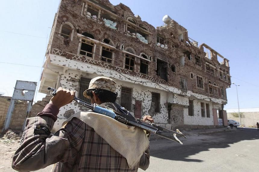A Shi'ite Houthi rebel walks along a street in Sanaa Oct 16, 2014. It could have been something as simple as a barking dog that alerted Al-Qaeda guards as US Special Forces approached a compound in Yemen just after midnight where American journalist 