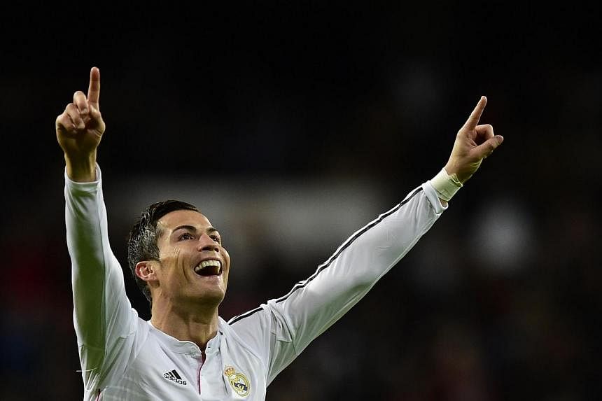 Real Madrid's Portuguese forward Cristiano Ronaldo celebrates after scoring in Madrid on Dec 6, 2014. Ronaldo netted a record 23rd hat-trick in La Liga and his 200th goal in the Spanish top flight as Real Madrid equalled a Spanish record of 18 consec
