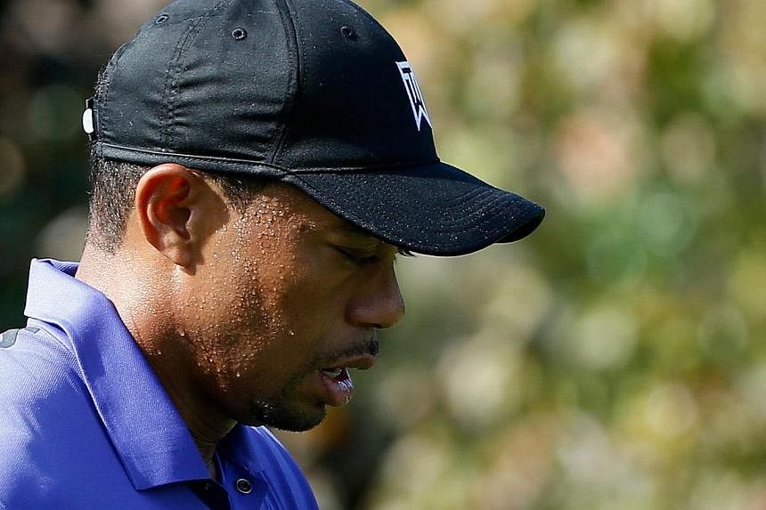 Tournament host Tiger Woods (above) battled a case of nausea as he soldiered through the third round's front nine in one under par at the Hero World Challenge on Saturday. -- PHOTO: AFP