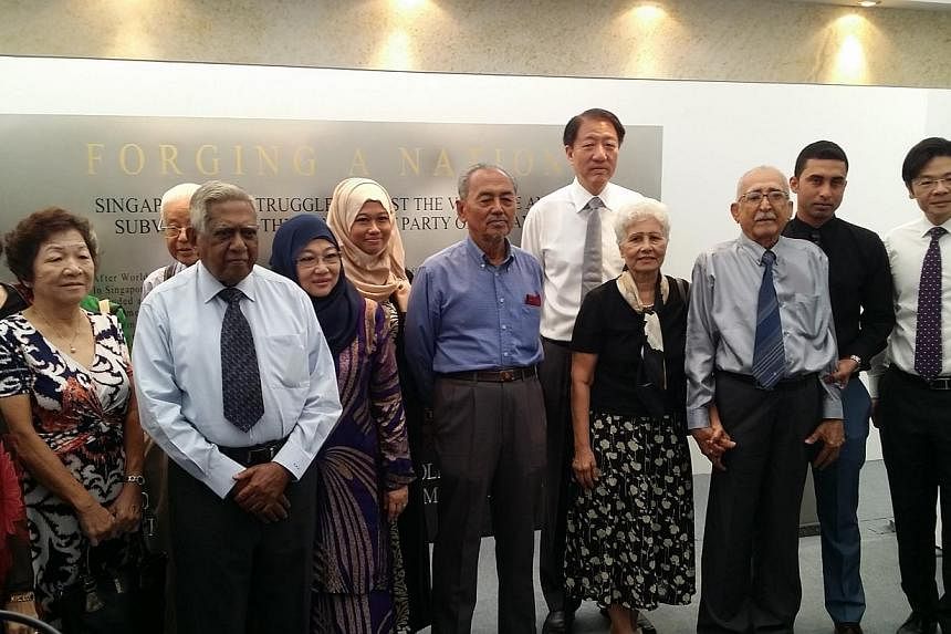 Former President S R Nathan (third from left), Deputy Prime Minister and Minister for Home Affairs Teo Chee Hean (centre in white shirt), and Minister for Culture, Community and Youth Lawrence Wong (right) with people who have lived through the fight