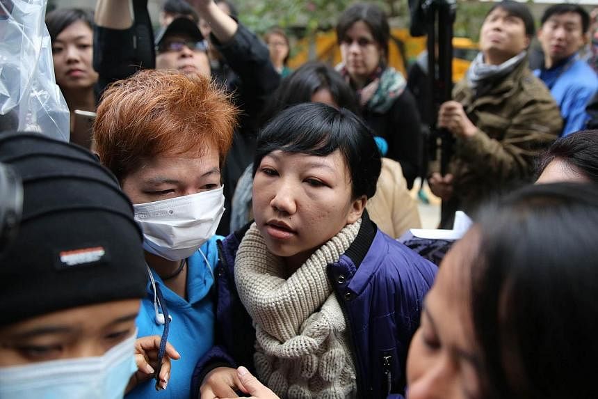 Erwiana Sulistyaningsih arrives at the Wanchai Law Courts to begin giving evidence against her former employer who is accused of abuse and toture in Hong Kong on Dec 8, 2014. -- PHOTO: AFP&nbsp;