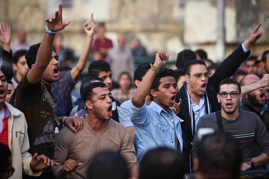Egyptian protersters shout slogans on Abdel Moneim Riad Square in the capital Cairo on Dec 5, 2014, during a demonstration against a court's decision to drop a murder charge against ousted president Hosni Mubarak.&nbsp;The Canadian Embassy in Cairo w