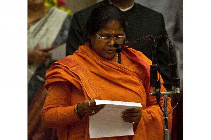 Bharatiya Janata Party leader Sadhvi Niranjan Jyoti takes an oath during a swearing-in ceremony at The Presidential Palace in New Delhi on Nov 9, 2014.&nbsp;India's parliament returned to business on Monday after the opposition dropped its demand for