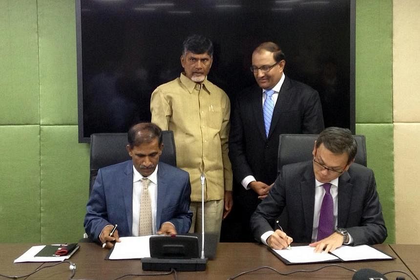 International Enterprise Singapore CEO, Mr Teo Eng Cheong (seated, right),&nbsp;and the Infrastructure Corporation of the Andhra Pradesh representative, Dr Sambasiva Rao (seated, left),&nbsp;signing a memorandum of understanding on Dec 8, 2014, to pr