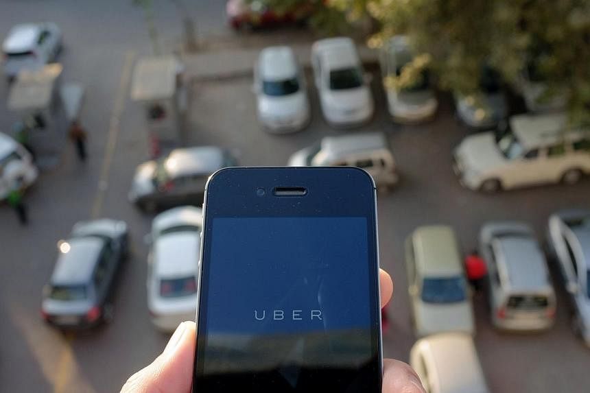 The Delhi city government said Monday it has banned Uber after a passenger accused one of the online taxi service's drivers of raping her. -- PHOTO: AFP