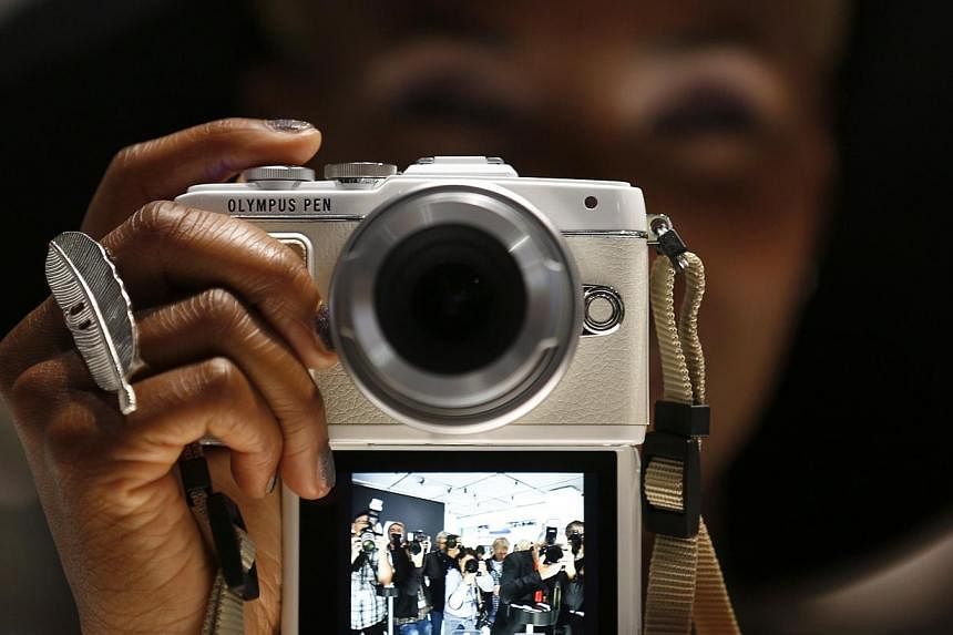 A former brokerage executive who helped camera giant Olympus cover up years of huge financial losses was given a suspended jail sentence on Monday, Dec 8, 2014. -- PHOTO: REUTERS