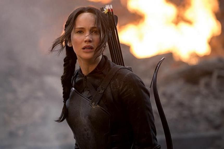 North American audiences continue to feast on The Hunger Games sequel Mockingjay Part 1, starring Jennifer Lawrence. -- PHOTO: CATHAY-KERIS FILMS