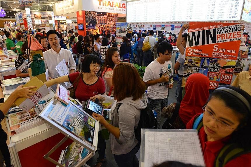 People at the Natas Holidays travel fair held in August 2014 at the Singapore Expo. -- PHOTO: ST FILE