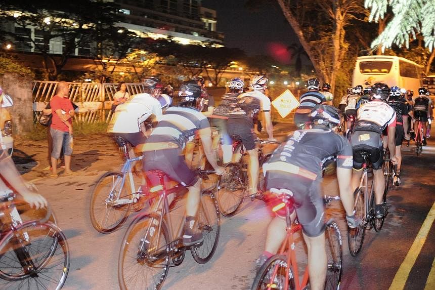Participants in HolyCrit, an illegal street cycling race, along Tanglin Halt Road. Two men have been arrested by the Traffic Police for their suspected involvement in promoting and organising illegal racing activities along Tanglin Halt Road last mon