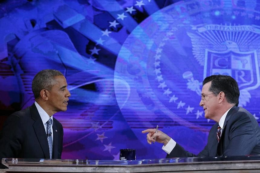 US President Barack Obama (left) appears on The Colbert Report with Stephen Colbert at the Lisner Auditorium at George Washington University in Washington on Dec 8, 2014. -- PHOTO: REUTERS