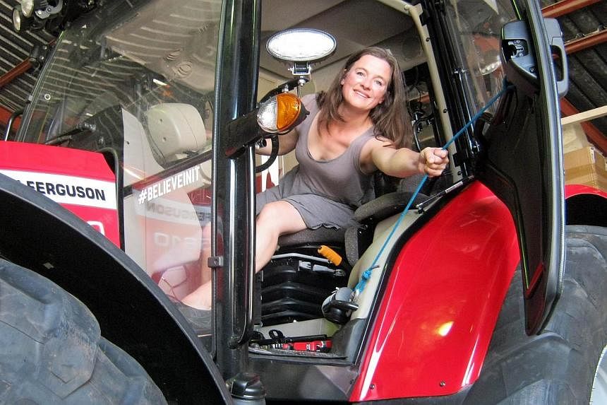 Manon Ossevoort in her tractor at her house in the South African Western Cape on Nov 9, 2014. -- PHOTO: AFP&nbsp;