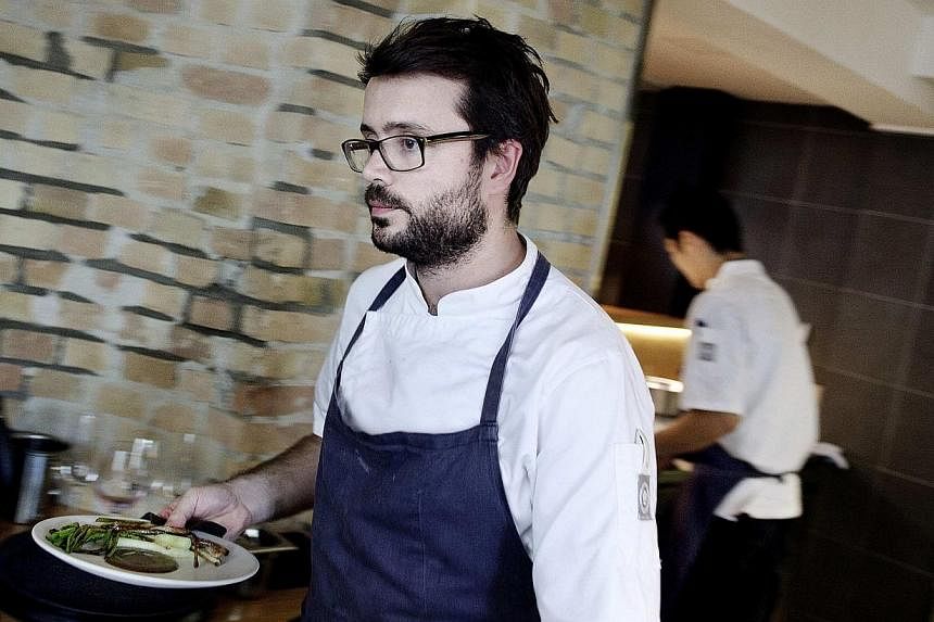 Chef Christian Puglisi works in the kitchen at Restaurant Relae in Denmark, on June 23, 2011. -- PHOTO: REUTERS