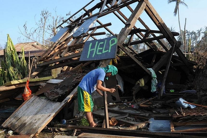 A resident trying to salvage materials from his house that was destroyed at the height of Typhoon Hagupit on Dec 9, 2014. The&nbsp;storm left the Philippines on Tuesday after killing at least 27 people and devastating remote coastal towns, but the go
