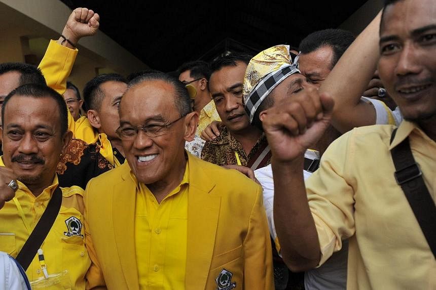 Indonesian tycoon Aburizal Bakrie (centre) is all smiles after winning another term as Golkar's chairman. The teflon-coated politician has survived various setbacks in a long and chequered career.