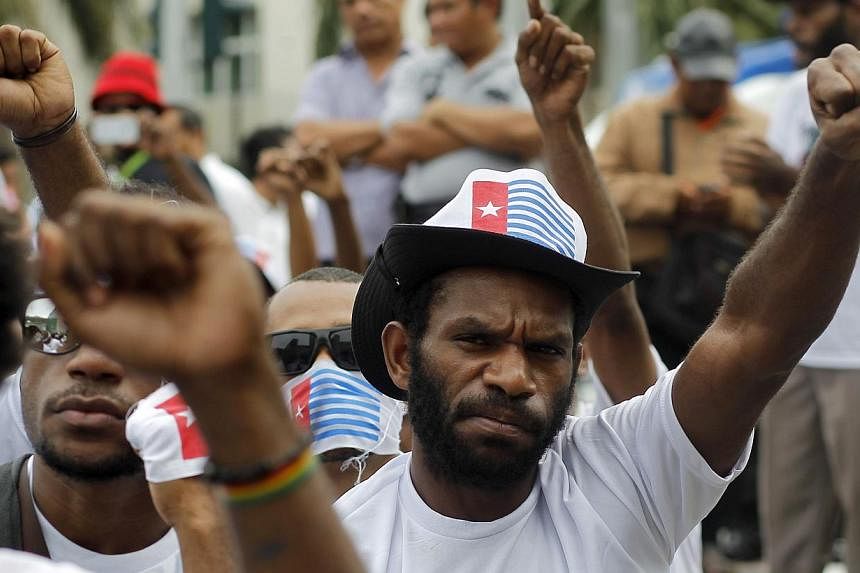 Papuan people shout slogans during a rally in Jakarta, Indonesia on Dec 1, 2014. At least four teenagers were shot dead in eastern Indonesia's restive Papua province in clashes with security forces, the authorities said on Dec 9, 2014, although right