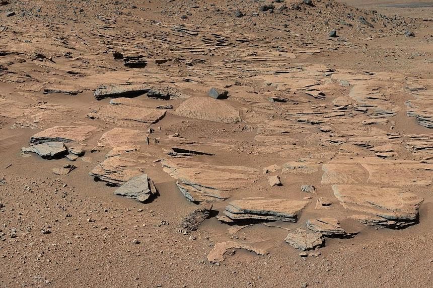This NASA handout photo shows beds of sandstone inclined to the southwest toward Mount Sharp and away from the Gale Crater rim. NASA scientists who have been studying observations from the Curiosity rover scouring the Red Planet, announced Monday tha