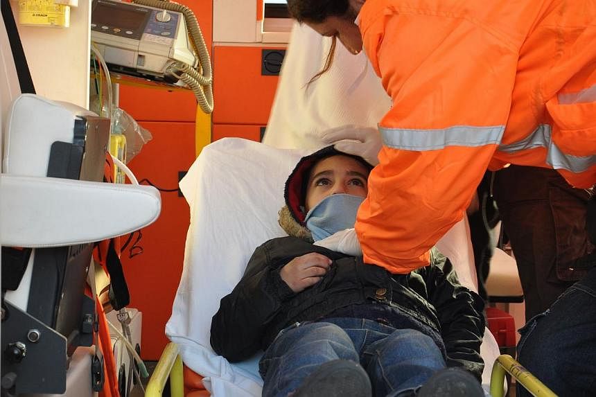 A Syrian child is given medical treatment in an ambulance after being rescued with some 200 refugees from a boat near the port of Kyrenia off the northern coast of the Turkish Republic of Northern Cyprus, after the vessel signalled for help when it h