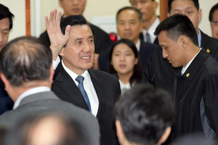 Taiwan President Ma Ying-jeou waving to his KMT party colleagues after resigning as chairman on Dec 3, 2014, after the ruling party's massive polls defeat. -- PHOTO: AFP
